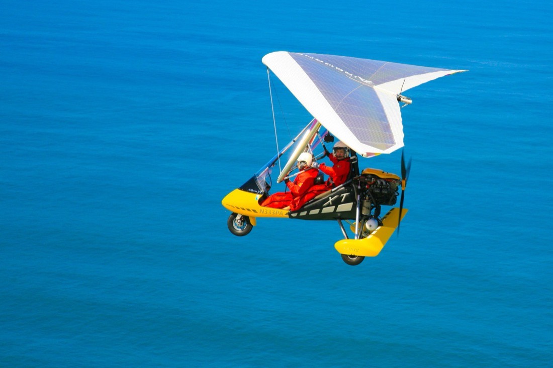The trike with a white wing over deep blue water