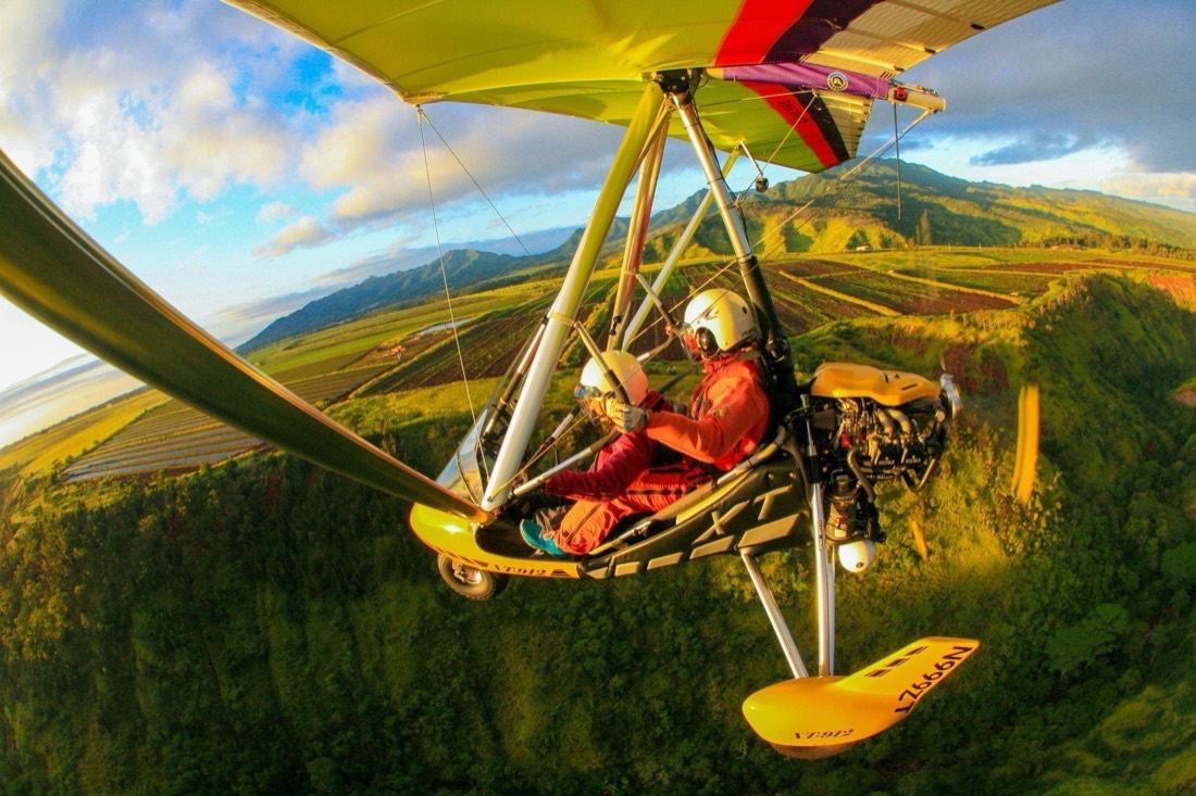 The trike over green fields, mountains and the coast beyond