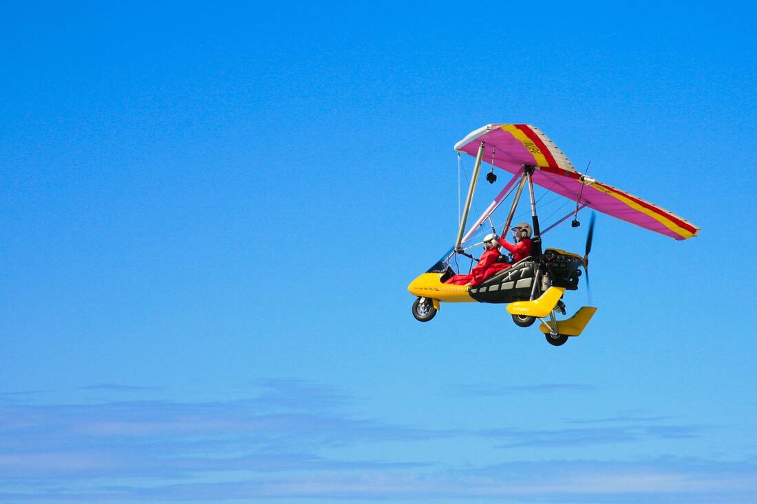 The trike small against a wide blue sky