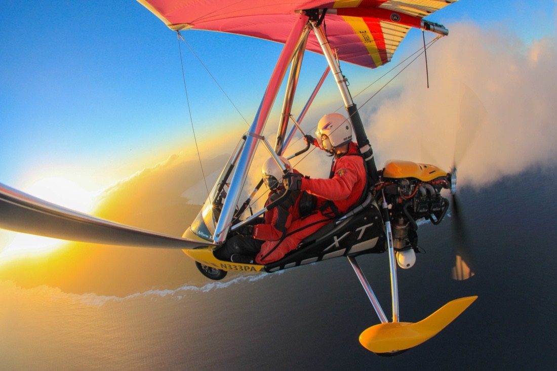 Two aboard in golden light, the sea and coastline below