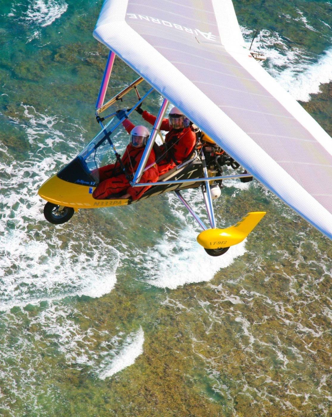 Looking down on the trike over reef and surf